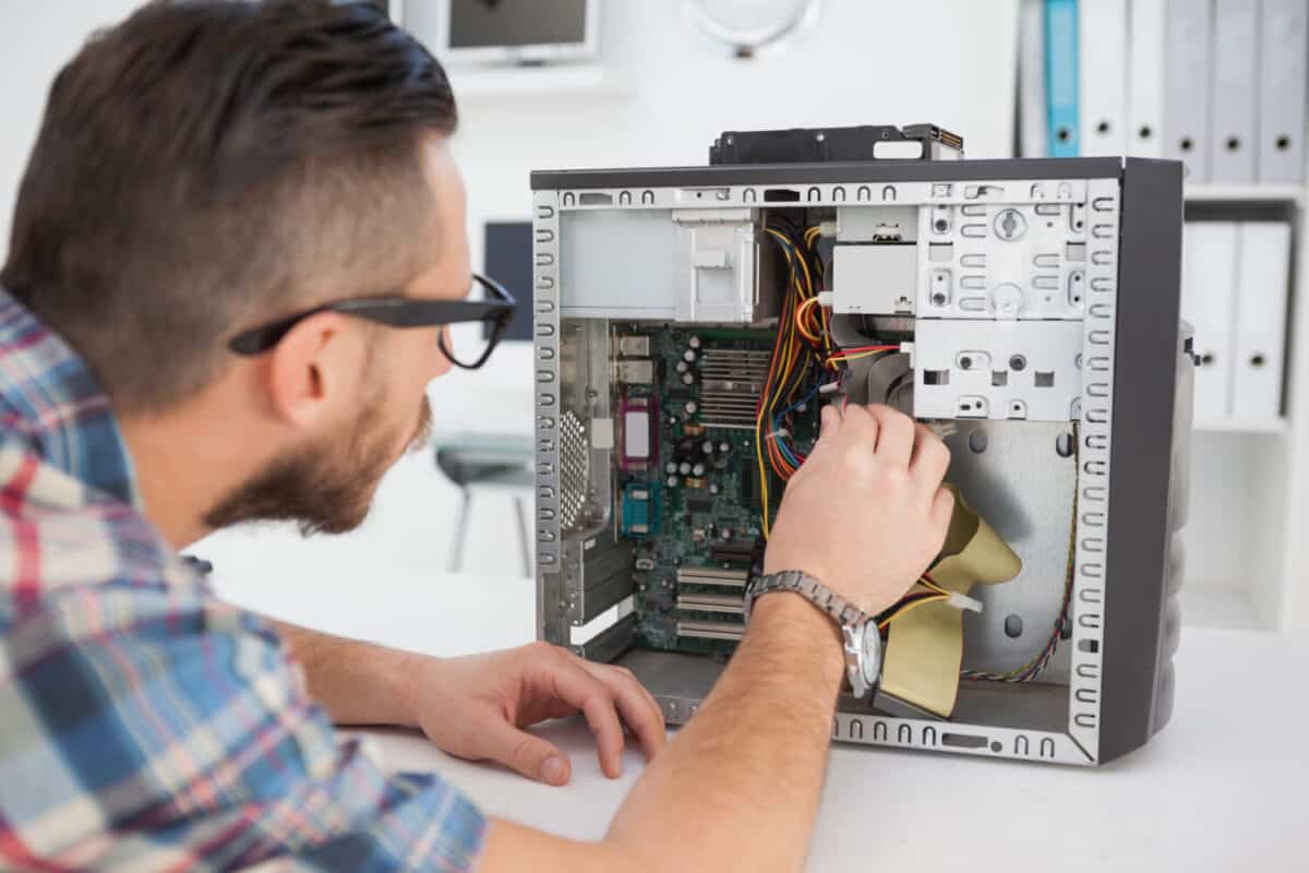 Man fixing broken computer.