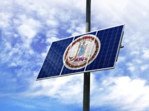 Solar panels against a blue sky with a picture of the flag State of Virginia