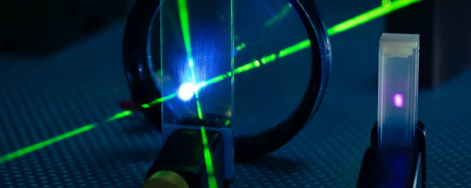 A laser is centered through the optics to adjust the position of each component. 