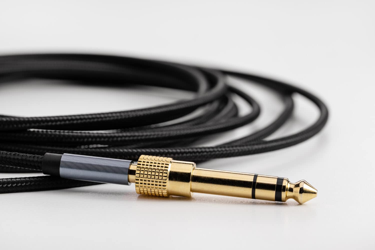 Braided flexible speaker cable with electronics plug, copy space. braid