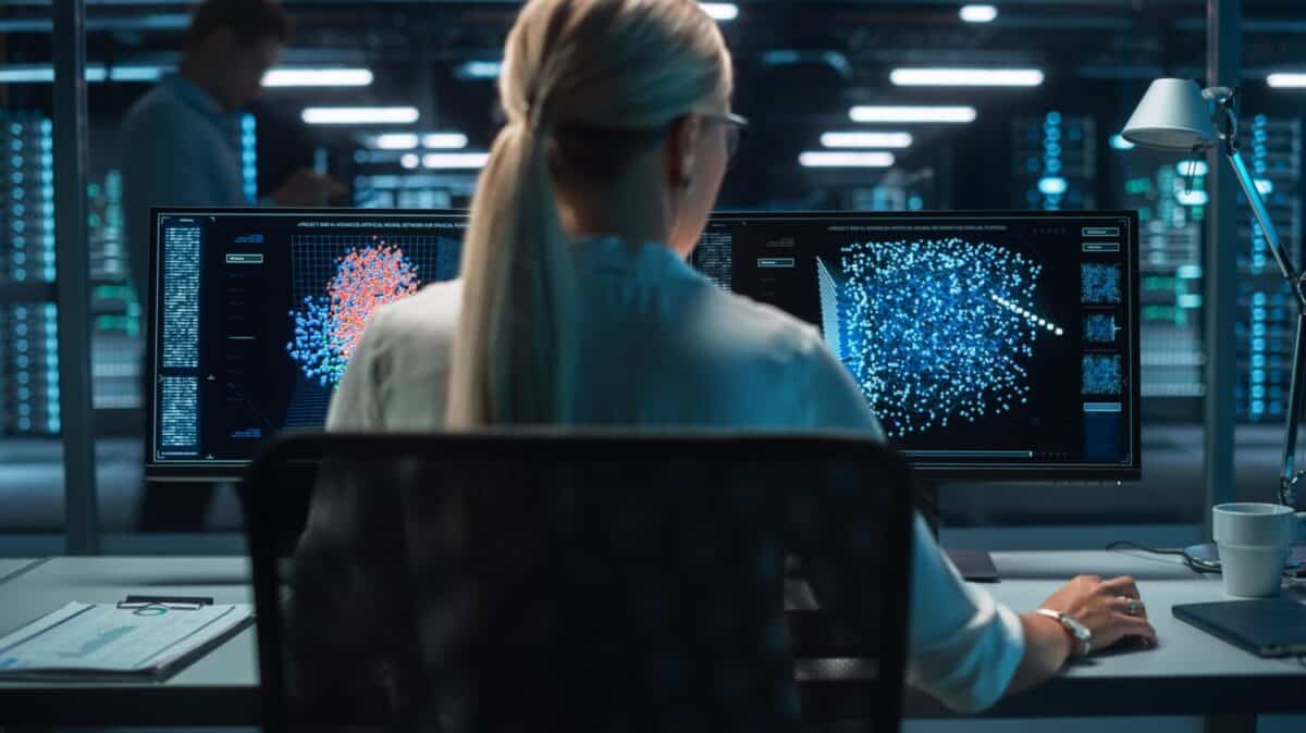 Portrait of Female Technical Operator Works with Display Showing Neural Network In the System Control Dark Room. Caucasian IT Technician Works on Artificial Intelligence. Big Data Scientific Research.