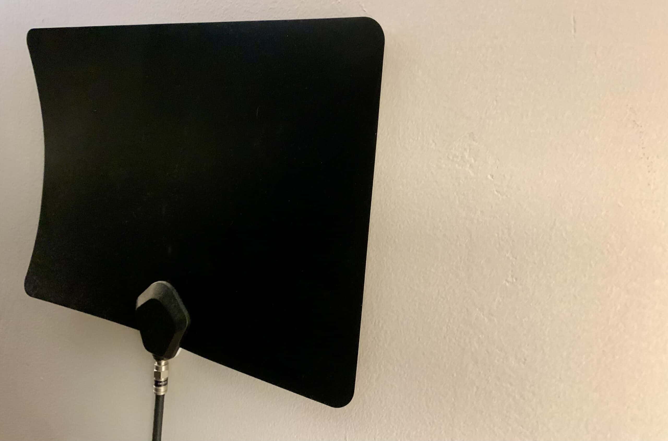 Indoor TV antenna attached to wall.