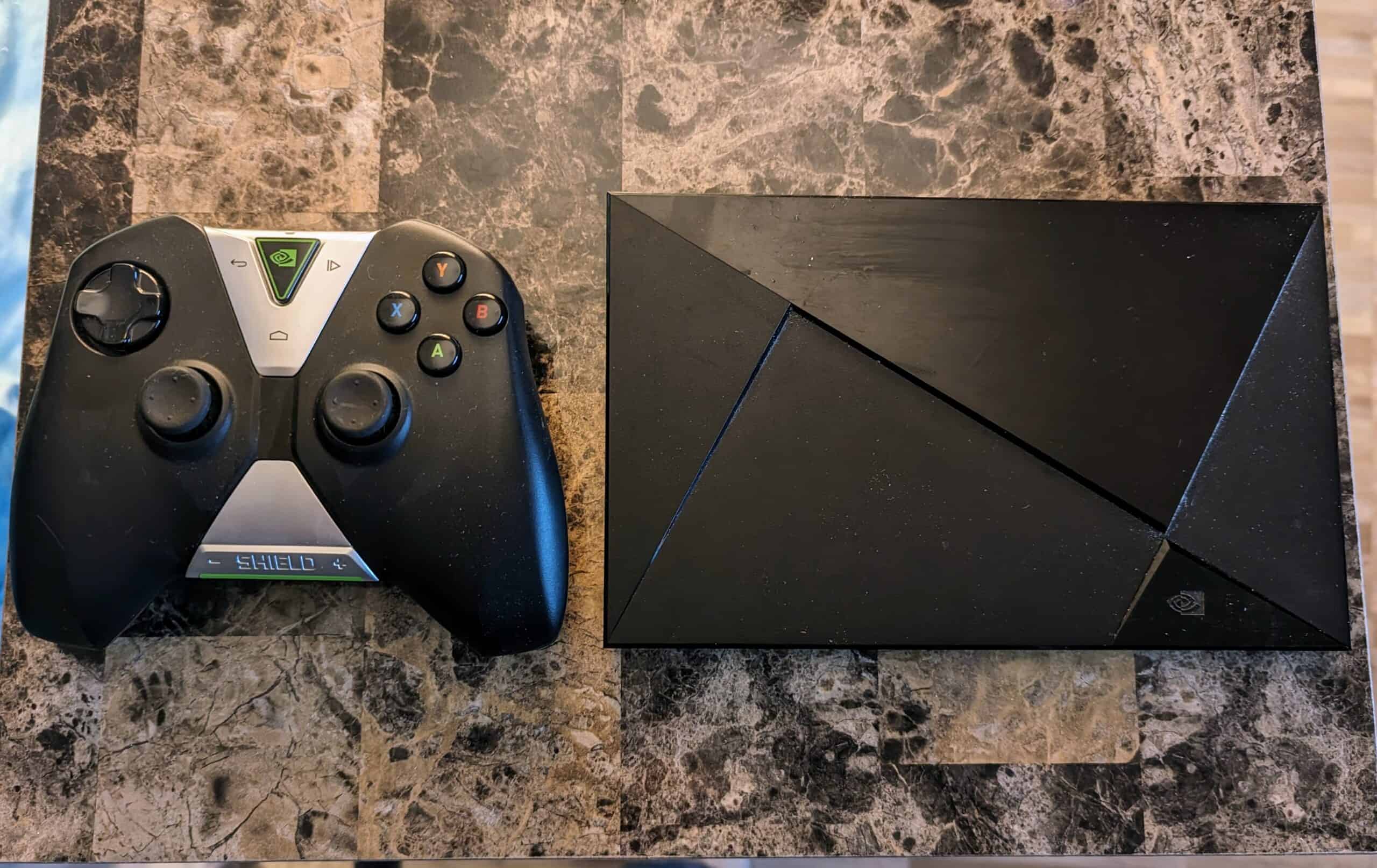 Featured Image For Reasons to Avoid a Nvidia Shield Article. An Nvidia Shield sitting next to its controller on a table.