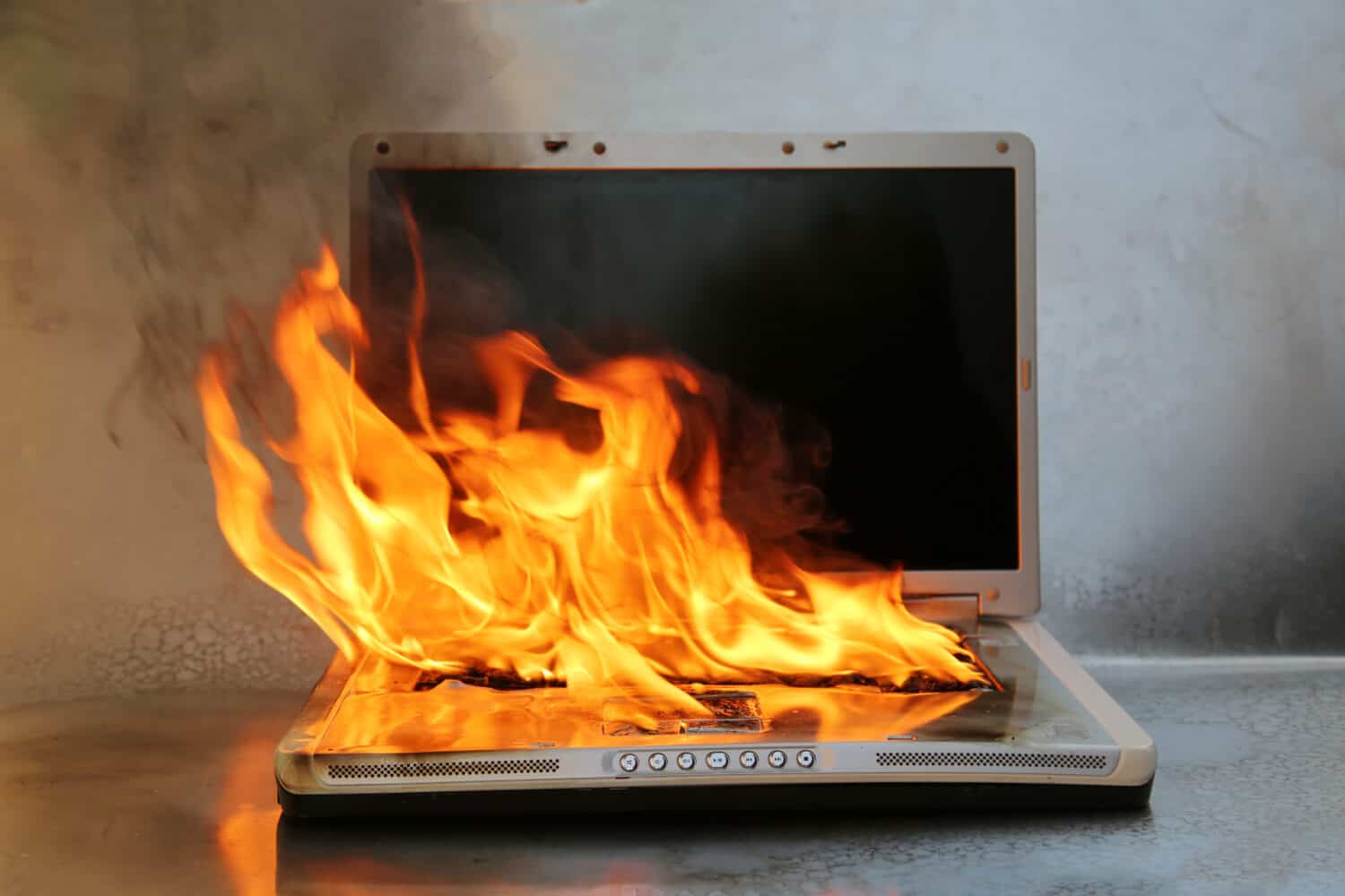 Laptop Damage. Laptop on fire and flames. Computer Repair. Flaming Fire laptop computer. 