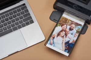 Compact printer with family image and laptop above top view