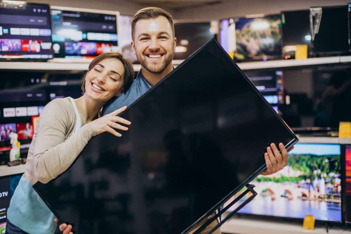 Couple buying television at store