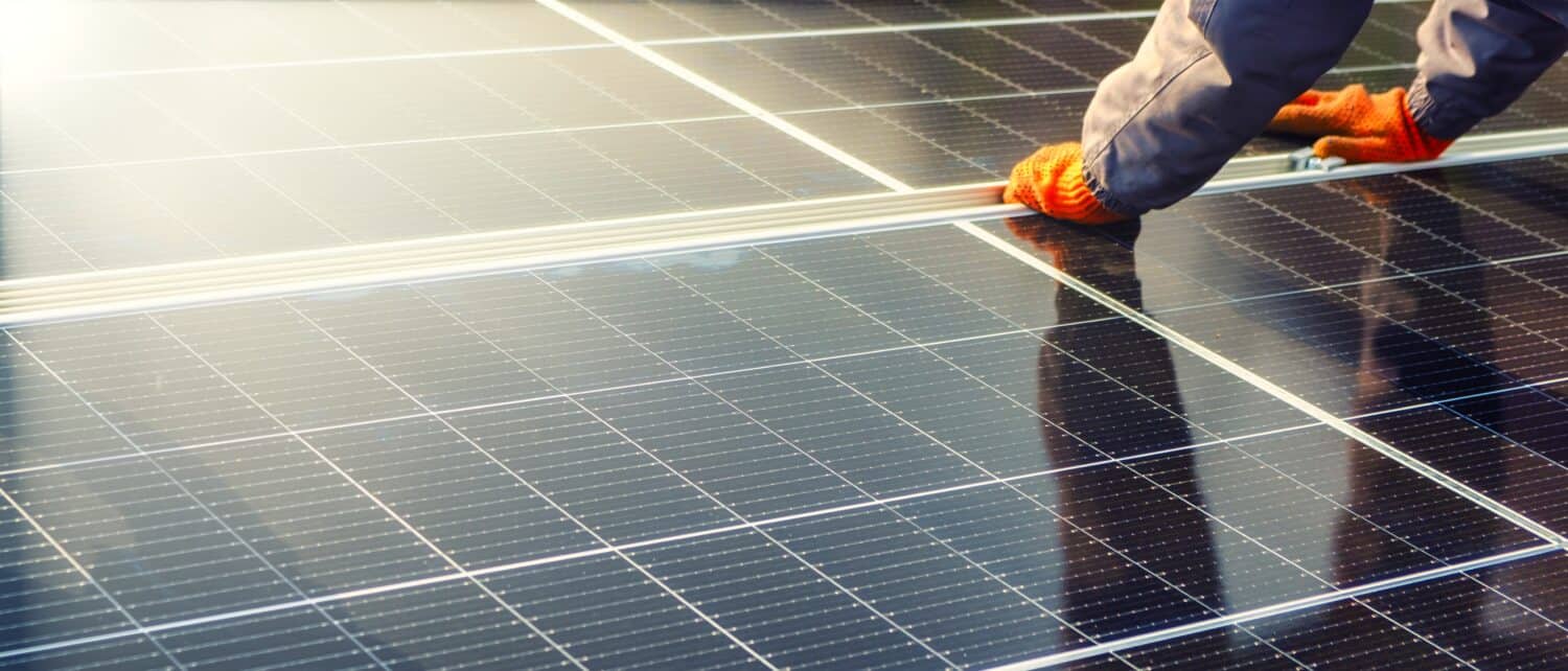 Close-up of solar cell, installing solar cell farm power plant eco technology. Solar cell panels in a photovoltaic power plant. Concept work of sustainable resources hands worker installing solar cell