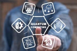 Man using virual touchscreen clicks text: QUANTUM COMPUTING. Concept of quantum computing. Quantum computer, artificial intelligence, innovative calculations, future digital technology. Supercomputing