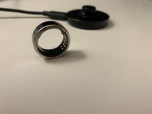Oura Ring with charger in background.