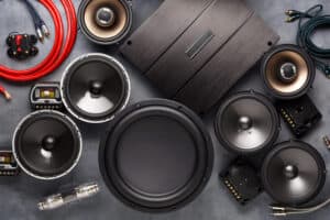 car audio, car speakers, subwoofer and accessories for tuning. Dark background. Top view.