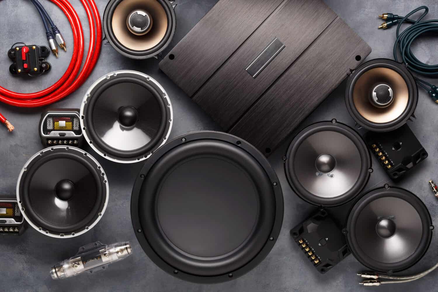 car audio, car speakers, subwoofer and accessories for tuning. Dark background. Top view.