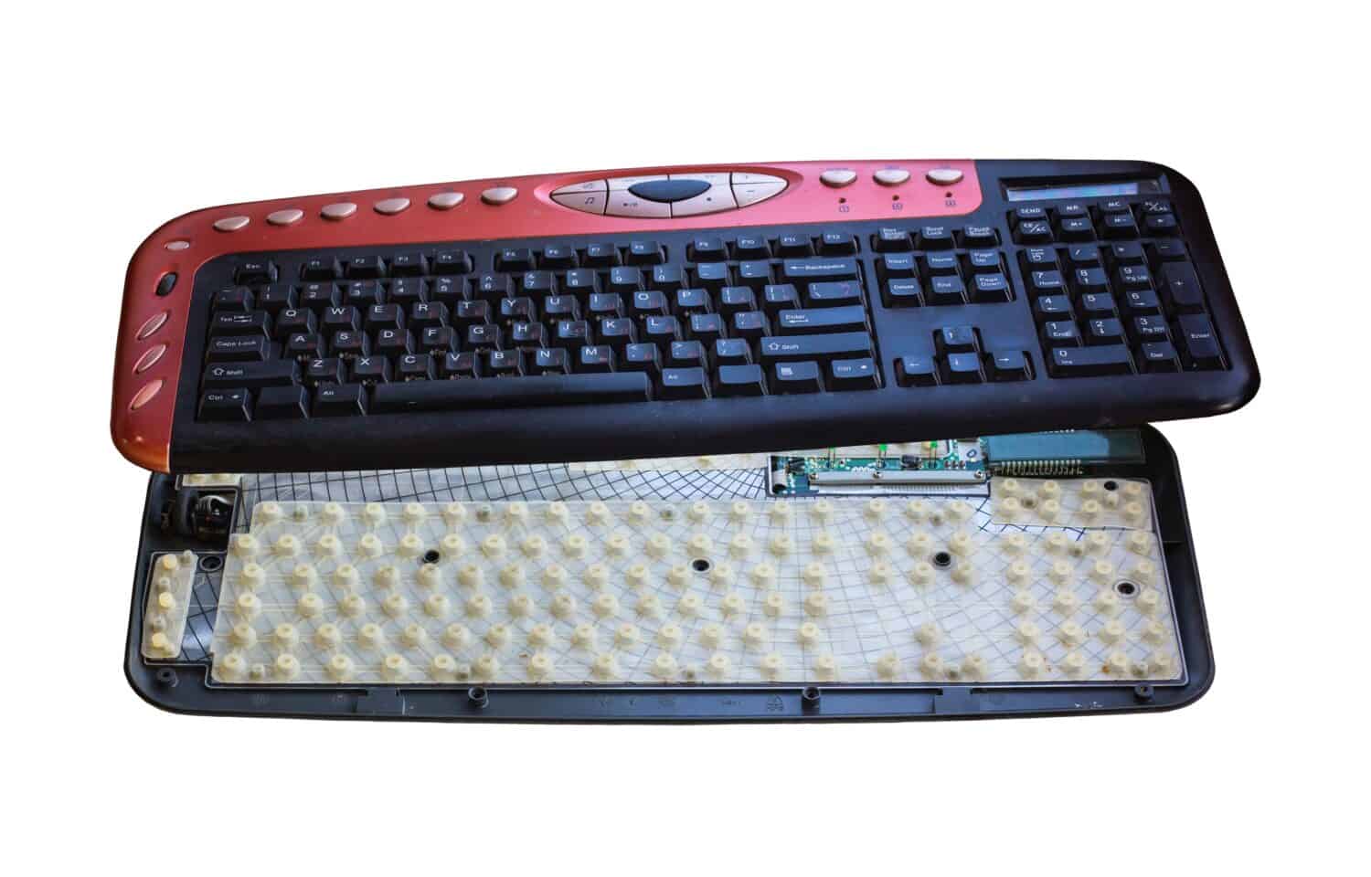Disassembled keyboard isolated on white background. Membrane plate at the bottom and keyboard housing at the top