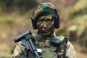 British armed forces lady soldier guarding pose . High quality photo