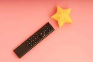 the TV control panel and a yellow star on the end of the remote. remote control in the form of a magic wand. society management and the magic of television
