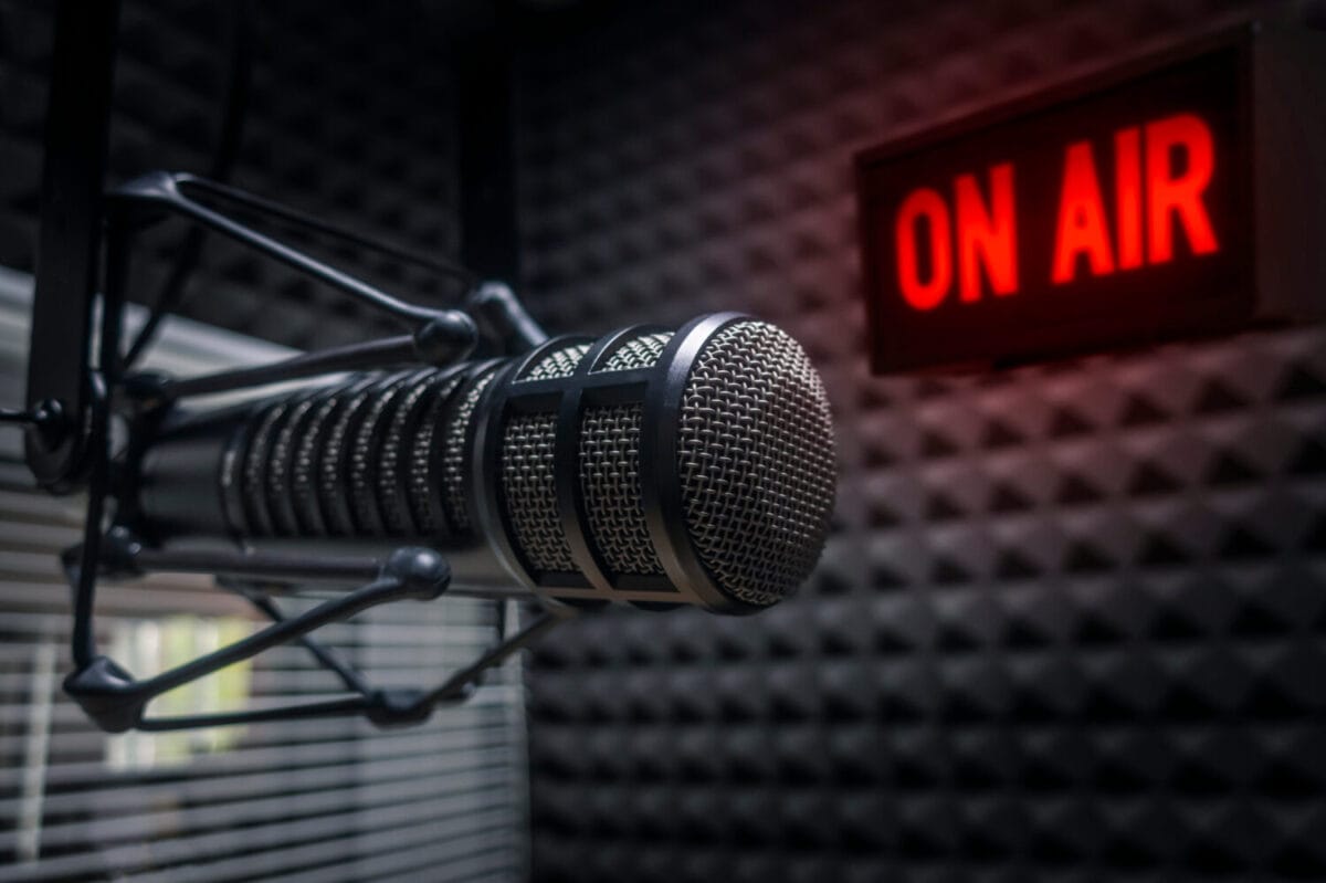 Professional microphone in radio station studio and on air sign