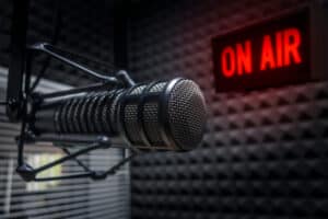 Professional microphone in radio station studio and on air sign
