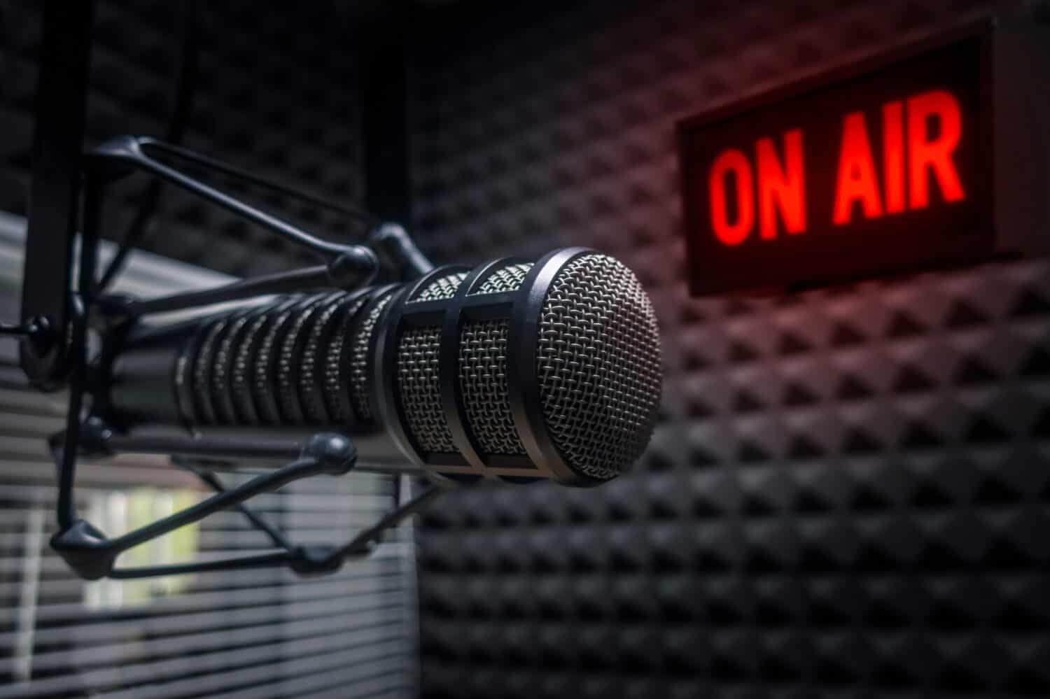 Professional microphone in radio station studio and on air sign