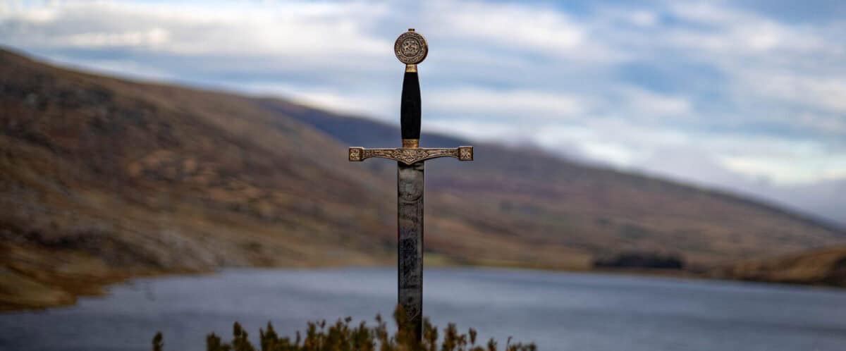 The sword excalibur is shown with lake Ogwen in the background and Tryfan to the right.