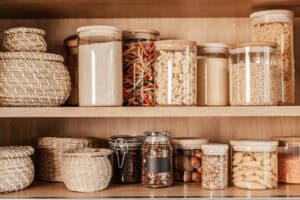 Organizing zero waste storage in kitchen. Pasta and cereals in reusable glass containers in kitchen shelf