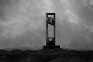 Horror view of Guillotine. Close-up of a guillotine on a dark foggy background. Execution concept