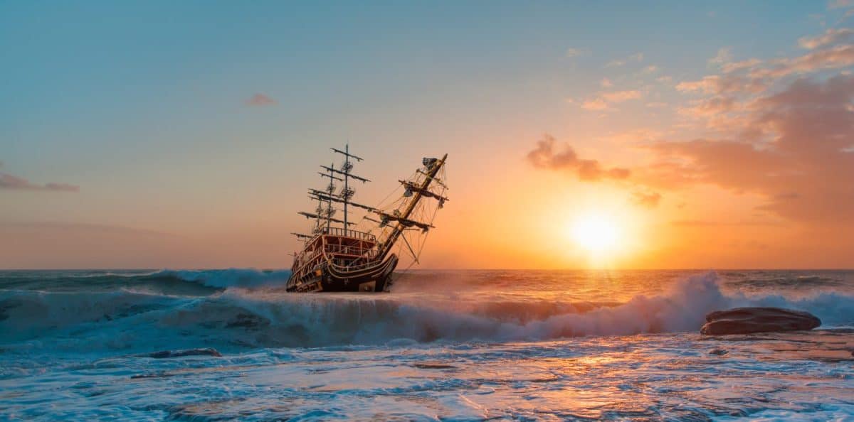 Sailing old ship in a storm sea in the background stormy clouds