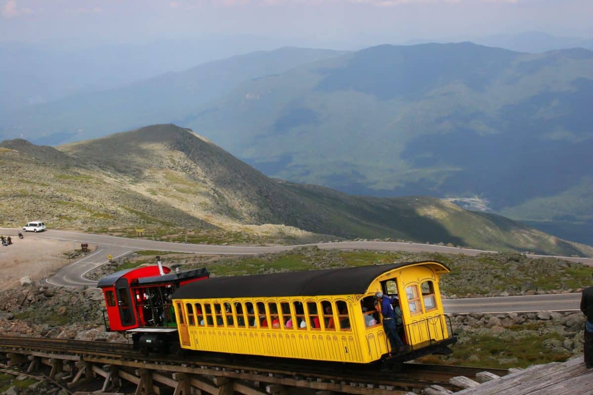 mountain landscape with cog railway steam train slowly driving up the mountain