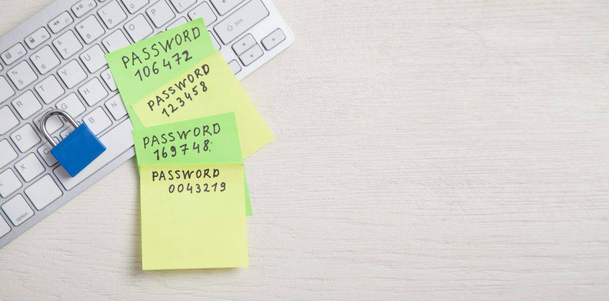 Password message written on sticky notes. Padlock on the keyboard. Password security