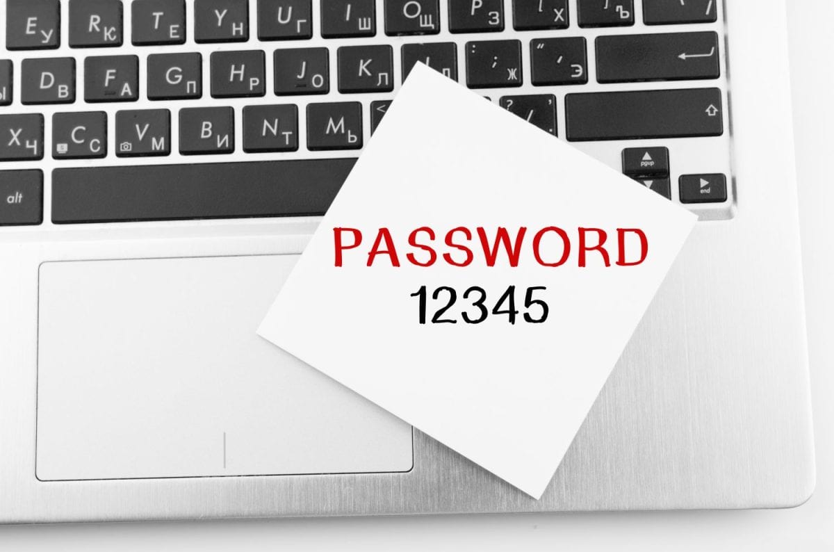 Laptop with memo sticks on the keyboard with text PASSWORD 12345 on it.