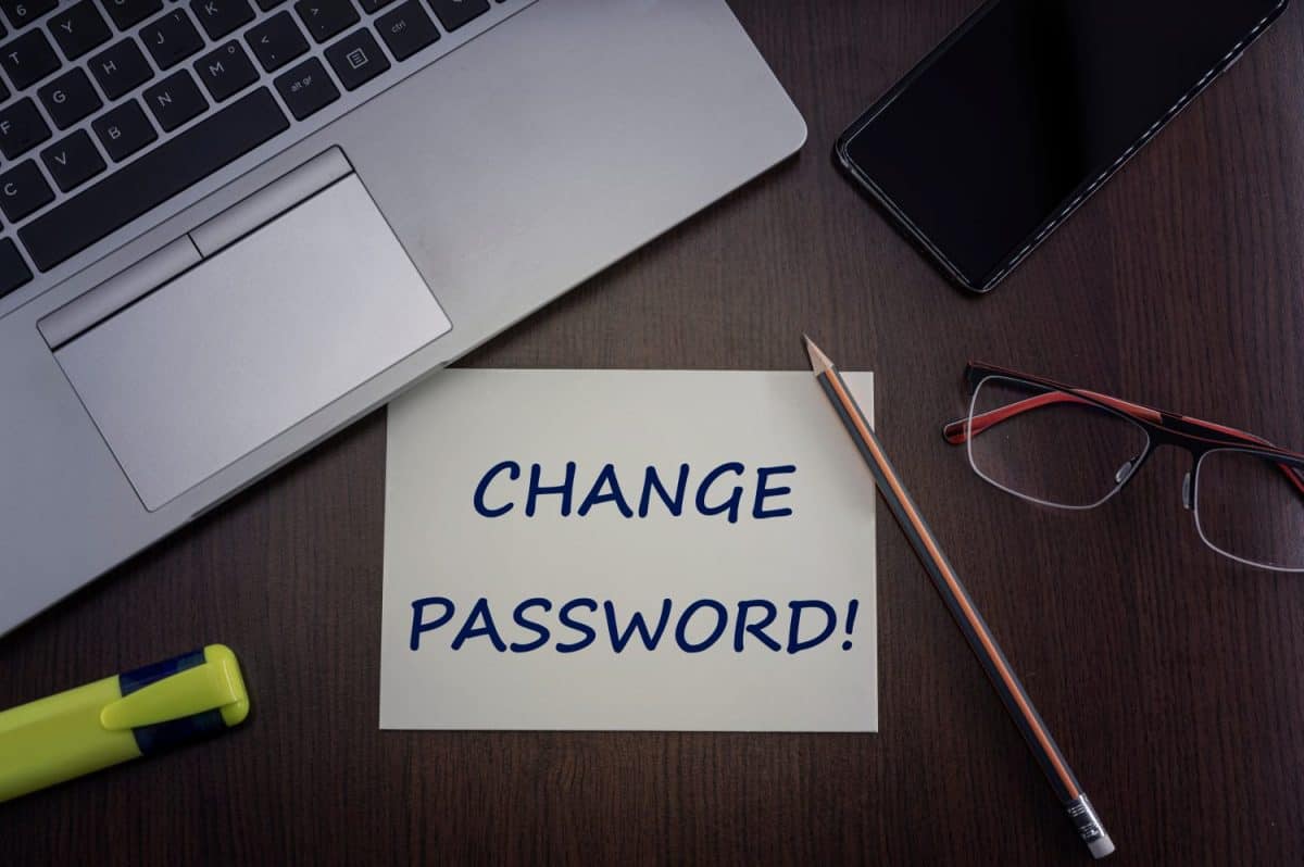 Change password card. Top view of office table desktop background with laptop, phone, glasses and pencil with card with inscription change password. Internet security concept.