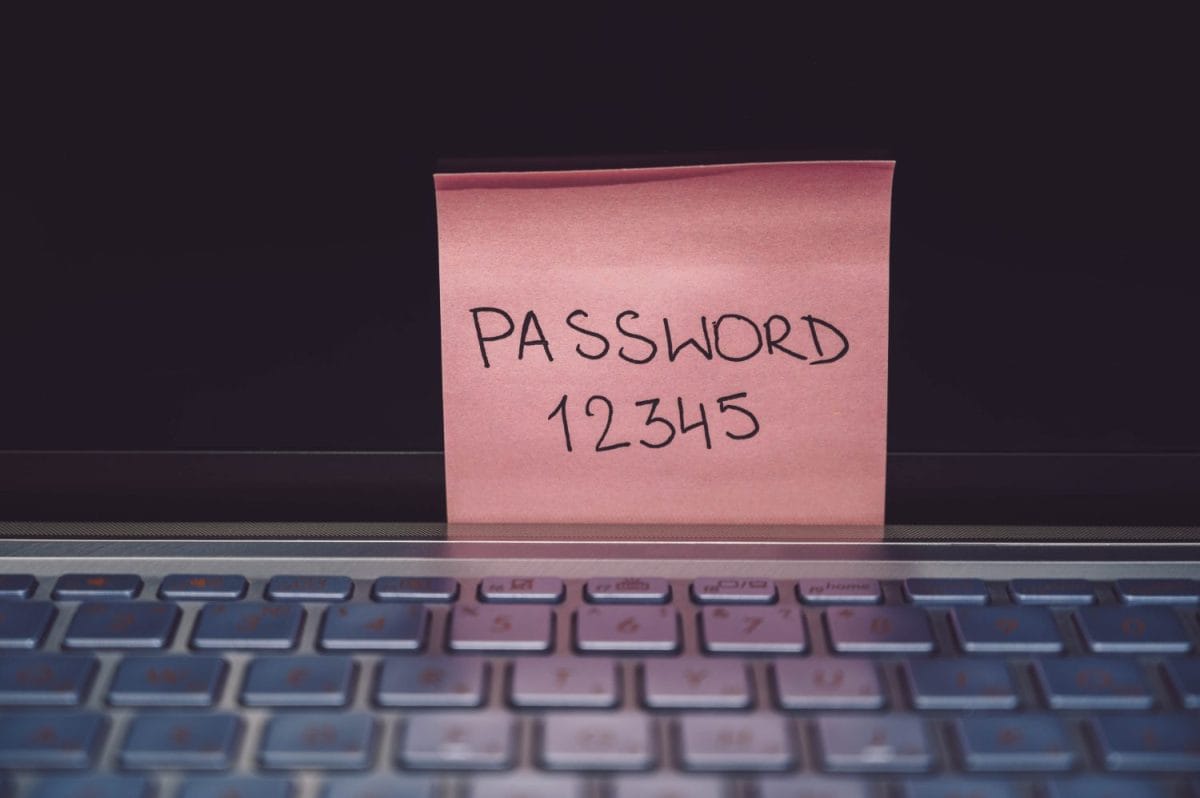 Easy Password Concept on computer keyboard. Password 12345 on pink sticky note