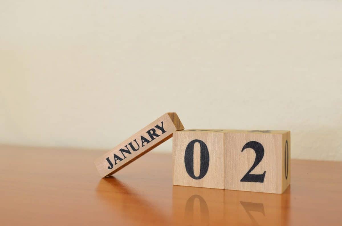 January 2, Date design with calendar cube on wooden table and white background.