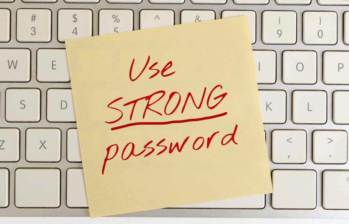 The concept of information security. The inscription "use a strong password" on a note on the pc keyboard.