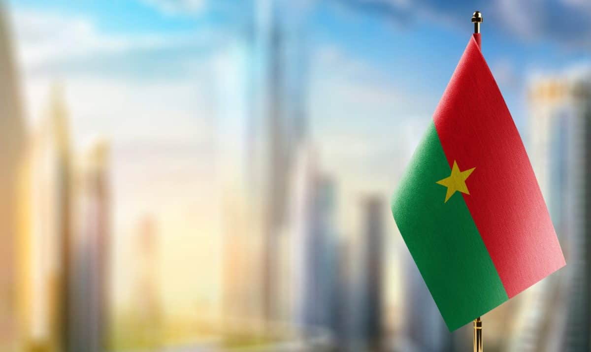 Small flags of the Burkina Faso on an abstract blurry background.