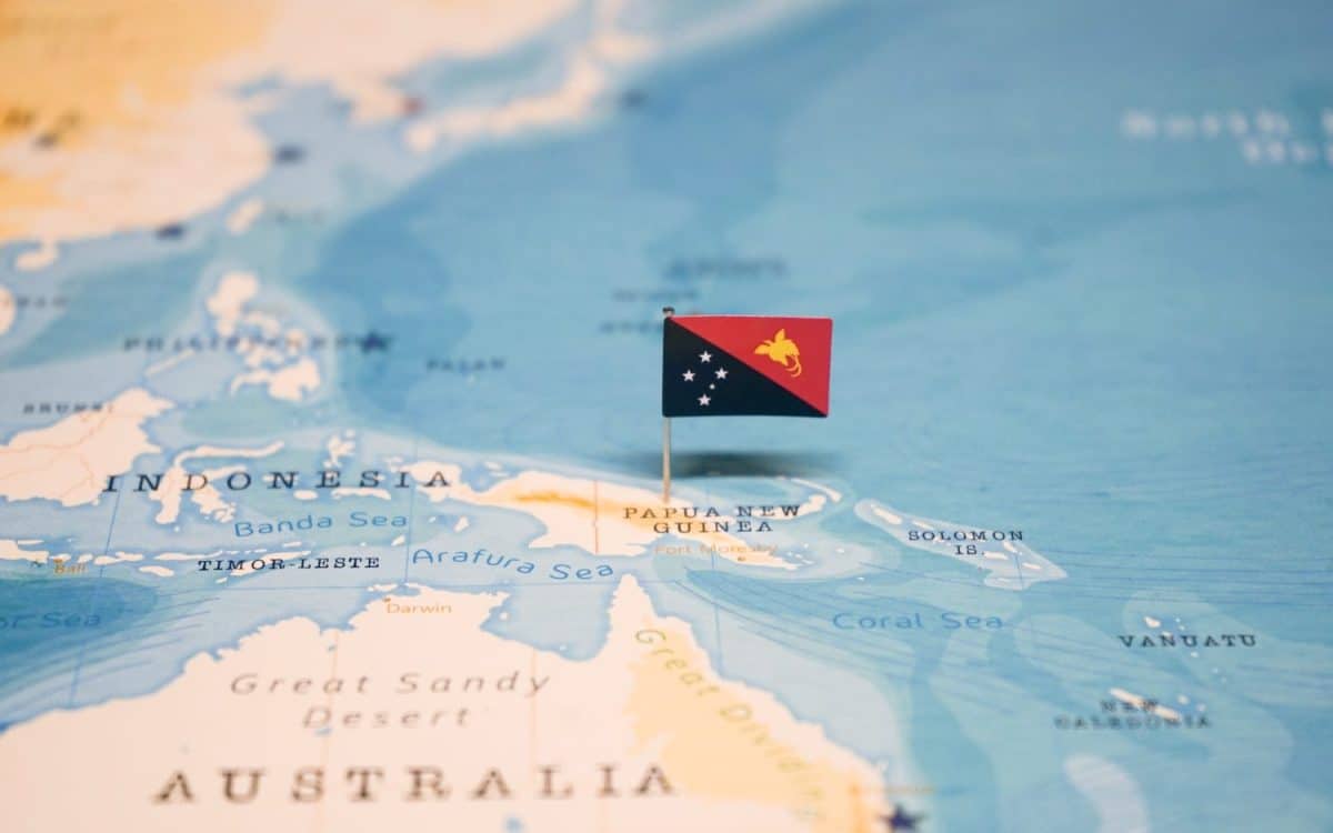 The Flag of Papua New Guinea on the World Map.