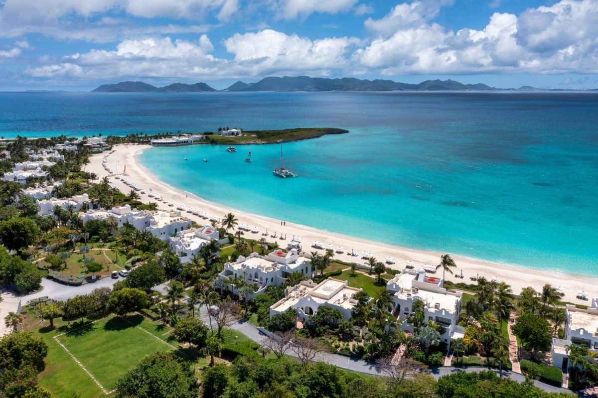 Aerial view of Maundays Bay and the circular beach at Cap Juluca with St. Martin in the distance on the island of Anguilla.