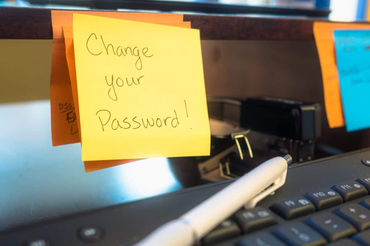 Sticky Note Reminder on Office Desk Saying "Change Your Password"