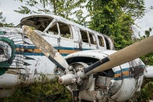 airplane wreckage in jungle - old propeller aircraft in forest -
