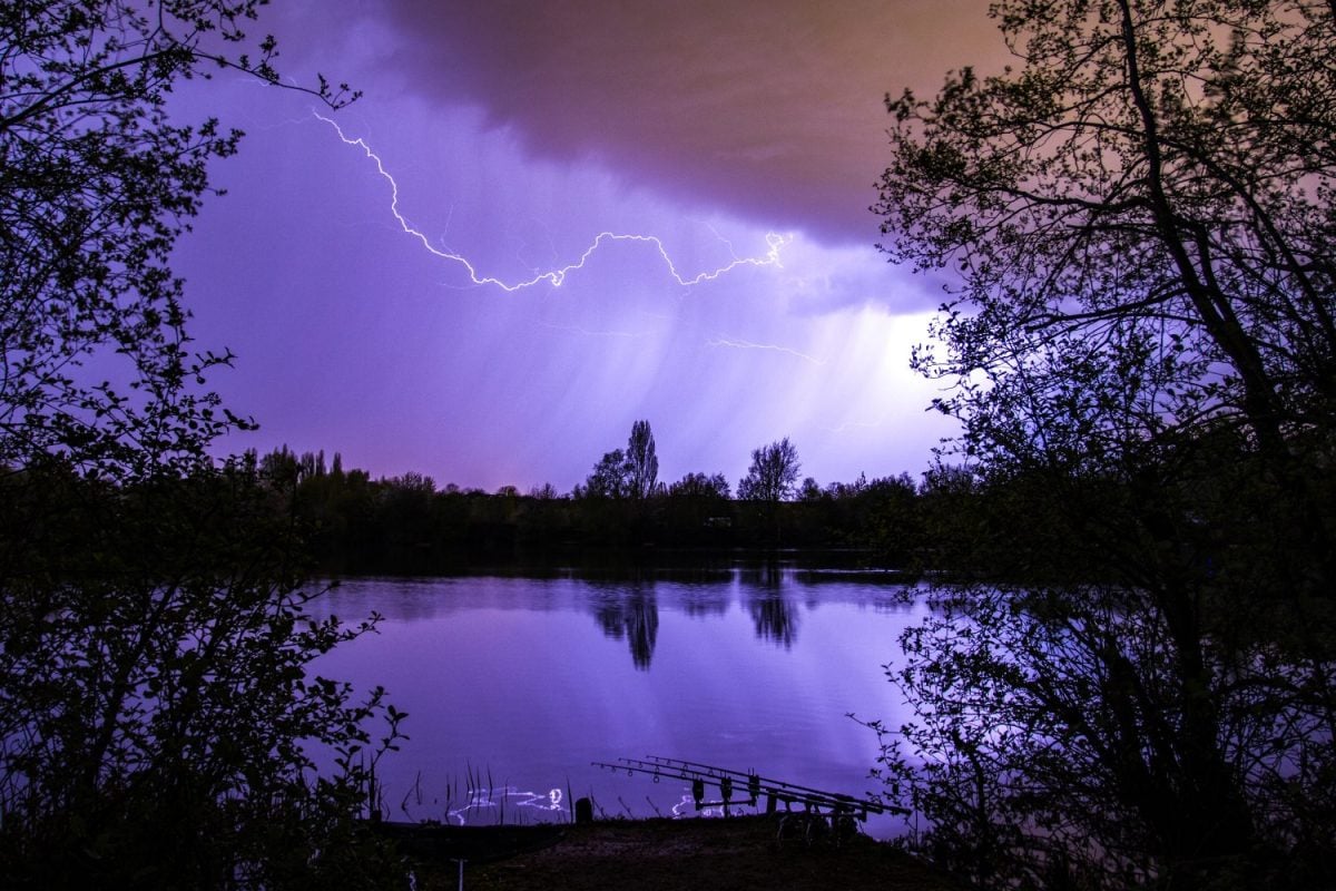 Lightning bolt as summer storm passes over carp fishing lake, Marlow, England, United Kingdon