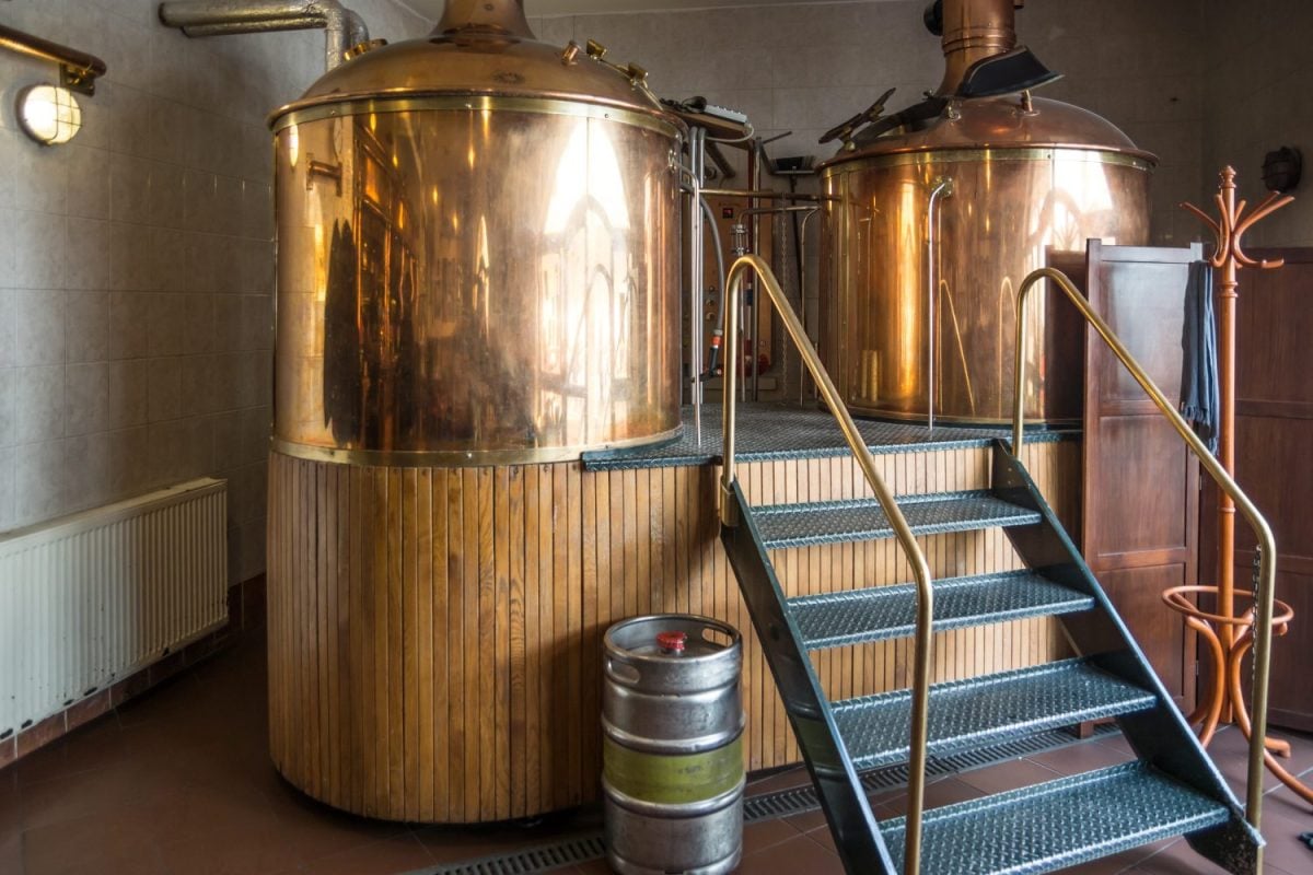 Line of two traditional brewing vessels in brewery.