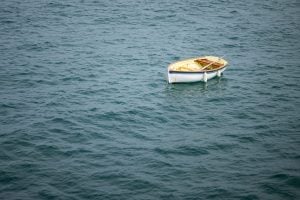 A small boat floating in the sea, water, daylight