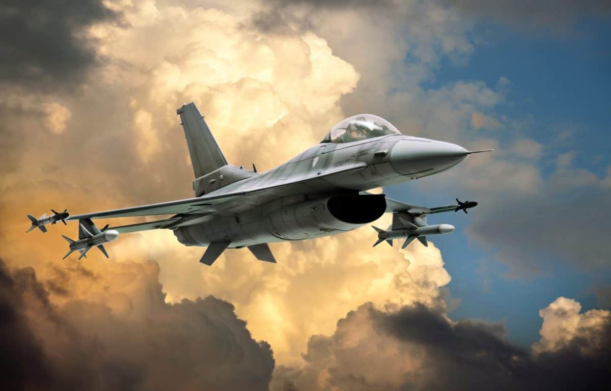 F-16 Fighting Falcon fighter jet (model) against dramatic clouds