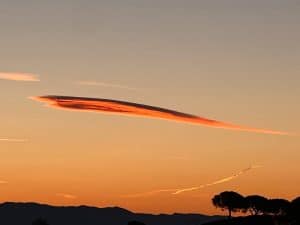 Strange cloud in a form of orange arrow