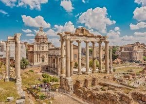 Roman Forum, in the center - the columns of the Temple of Saturn, followed by the Arch of Septimius Severus. Rome. Italy.
