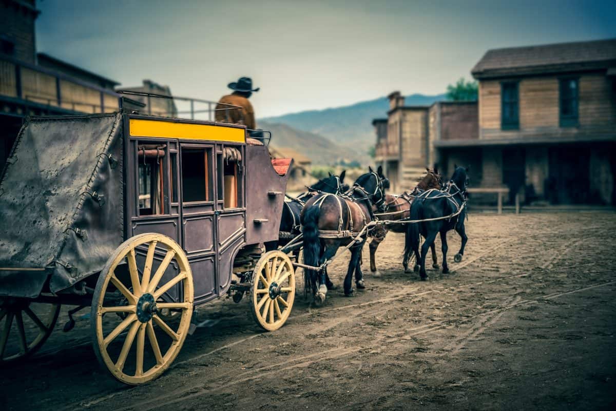 Stagecoach enters town square in American old wild West