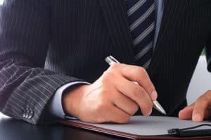 A business person who signs documents