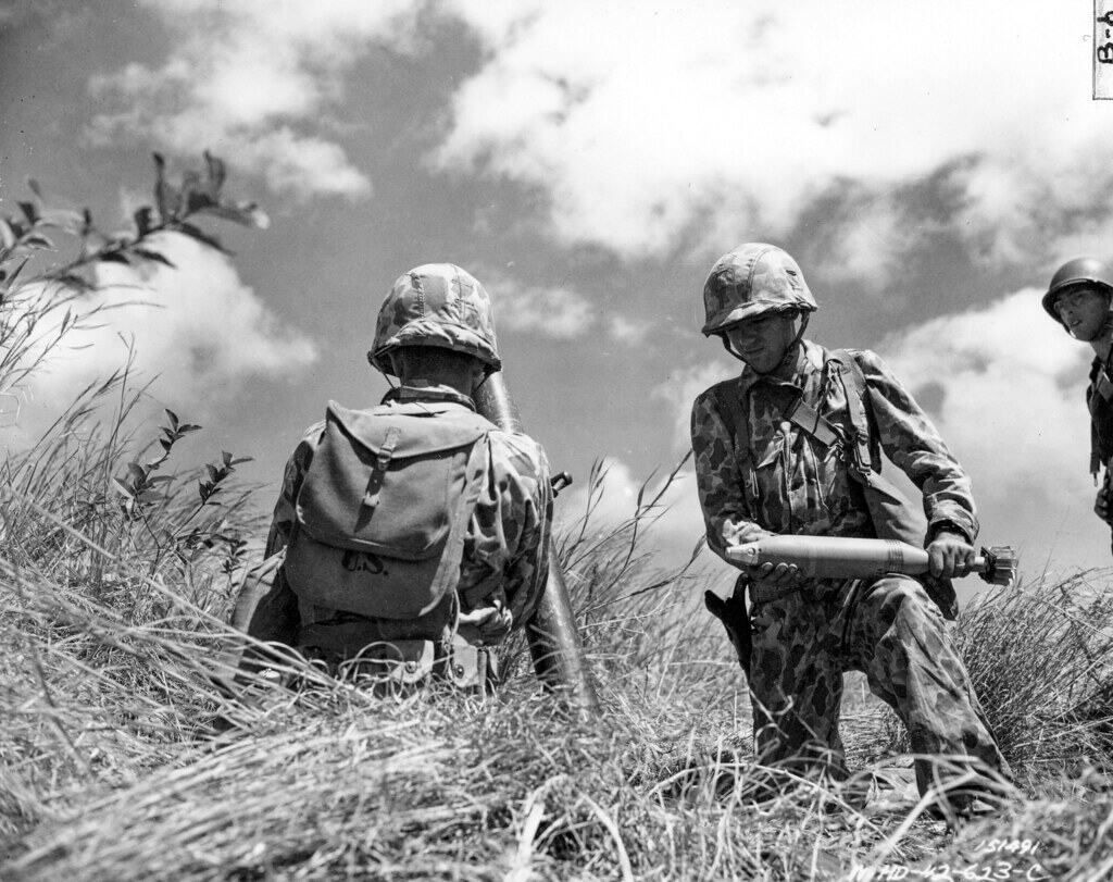 SC 151491- Pvt. Frank Rachew, displays one of the white phosphorus mortar smoke shells used during the problem for the designation of targets. Hawaii.