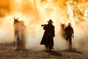 Portrait western cowboys riding horses, roping wild horses in Mexico and America.Smoke background.