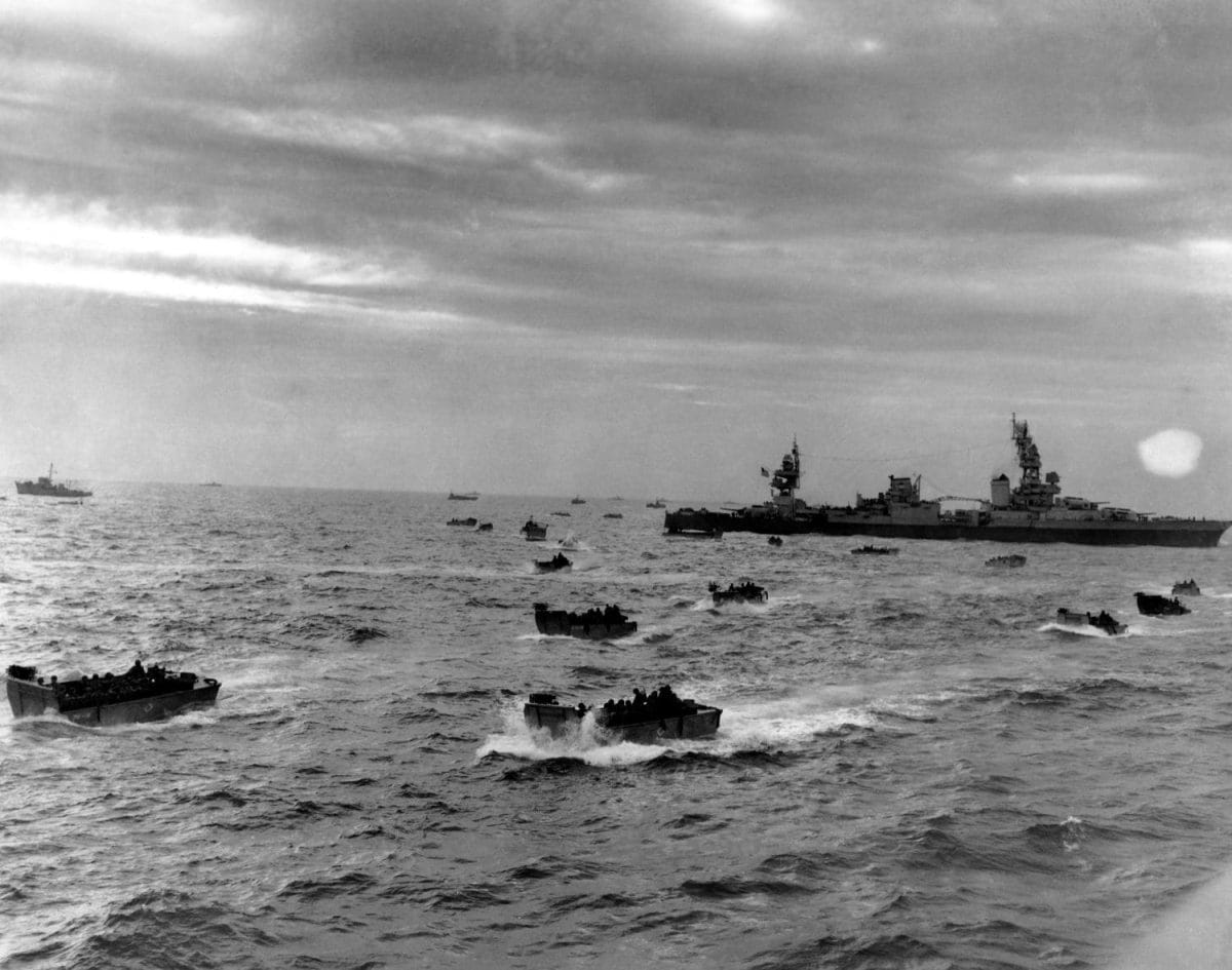 D-Day landing craft head for Omaha beach during the Normandy invasion on June 6, 1944. in right background is the cruiser USS Augusta, flagship of the Western Naval Task Force.
