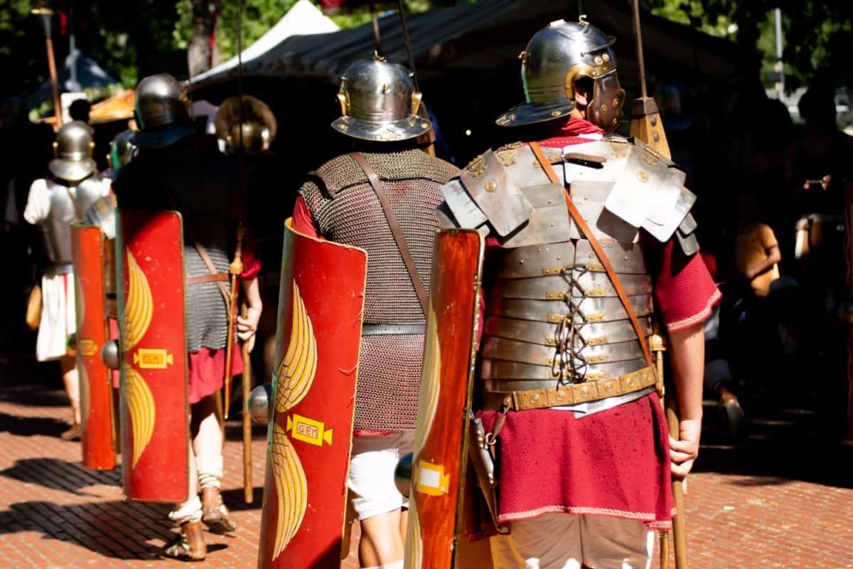 roman soldiers seen from behind with shields, roman army reenactment event