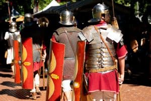 roman soldiers seen from behind with shields, roman army reenactment event